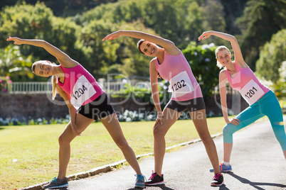 Female athletes warming up in park