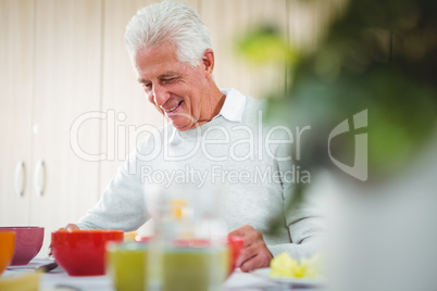 Senior man smiling during the lunch