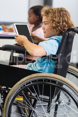 Disabled schoolboy using digital tablet Disabled schoolboy using digital tablet