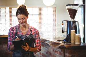 Waitress writing in a book