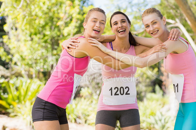 Portrait of young athlete women forming huddles