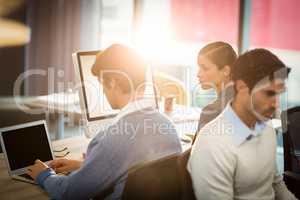 Man working on laptop with coworker