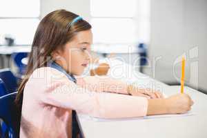 Schoolgirl studying in classroom