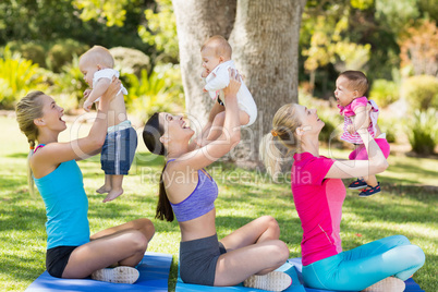 Women holding their babies while exercising