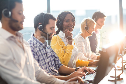 Team working on computer with headset