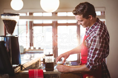 Waiter preparing coffee