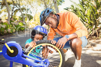 Family repairing a bike