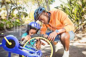 Family repairing a bike