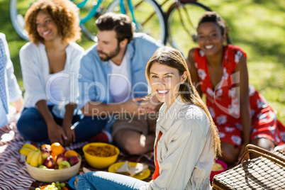 Woman sitting with her friends in park