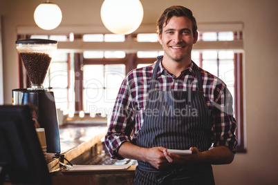 Portrait of bartender standing with notepad