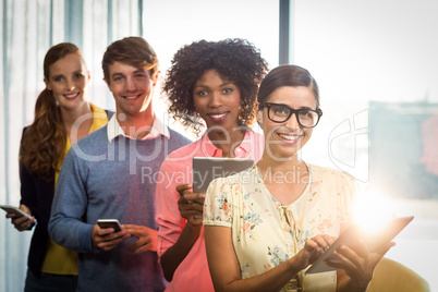 Portrait of business people using digital tablet and mobile phon