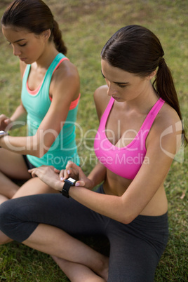 Beautiful women adjusting a time on wristwatch
