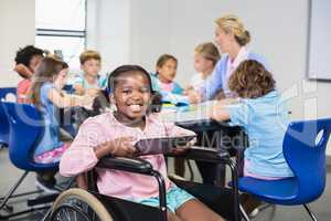 Disabled schoolgirl using digital tablet