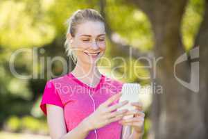 Beautiful woman listening music on mobile phone