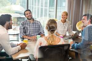 Business people holding coffee mug during a meeting