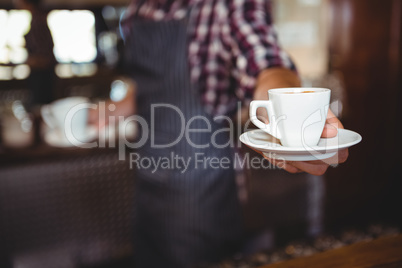 Waiter handing over a coffee