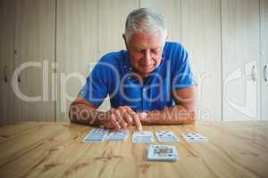 Senior man pointing at a card