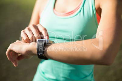 Woman adjusting a time on wristwatch