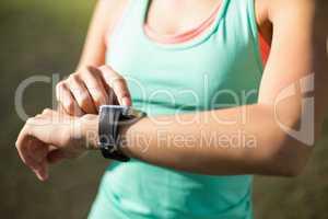 Woman adjusting a time on wristwatch