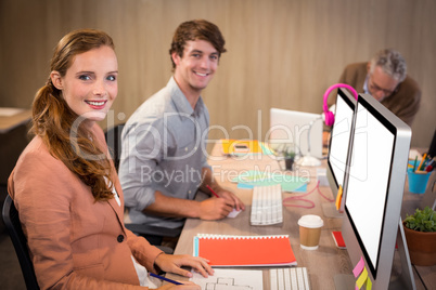 Smiling business people sitting in office