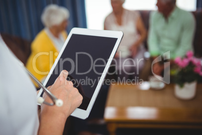 Close-up of a nurse holding a digital tablet