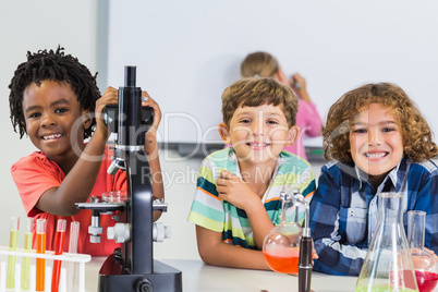 Portrait of kids doing experiment in laboratory