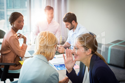Business people gossiping during meeting