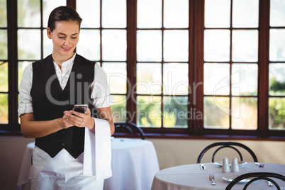 Waitress using mobile phone