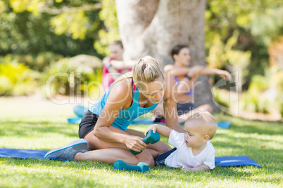 Woman with her baby while exercising