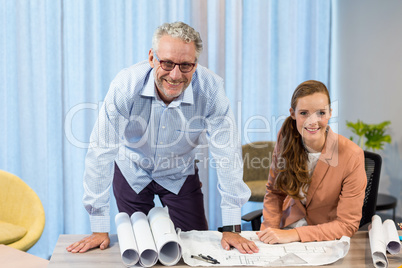 Businesswoman and coworker discussing blueprint