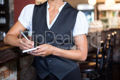 Waitress taking order on a notebook