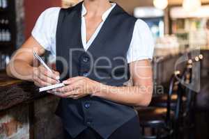 Waitress taking order on a notebook