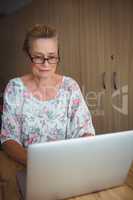 Smiling senior woman using a laptop