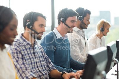 Team of colleagues working at their desk with headset