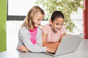 Kids using laptop in library