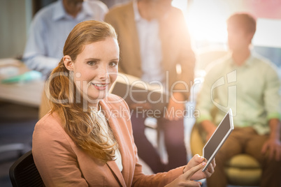 Businesswoman holding on digital tablet