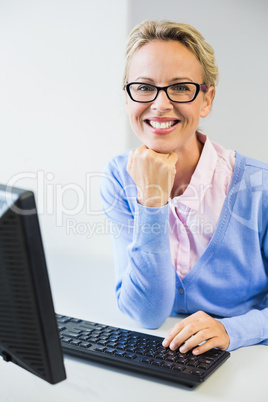 Teacher working on computer in classroom