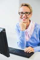 Teacher working on computer in classroom