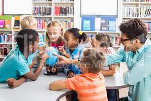 Teacher and kids discussing globe