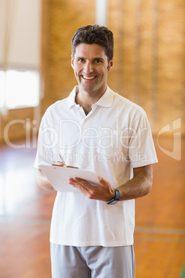 Portrait of sports teacher holding clipboard