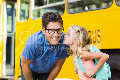 Schoolgirl about to kiss a teacher in front of school bus