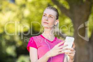 Beautiful woman listening music on mobile phone