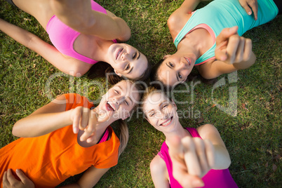 Beautiful young women lying and pointing