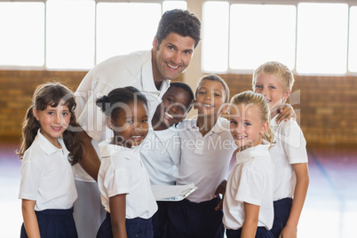 Portrait of sport teacher and students in school gym