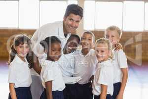 Portrait of sport teacher and students in school gym