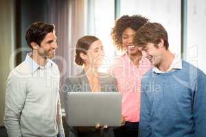 Business people having discussion over laptop