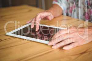 Old person touching a digital tablet