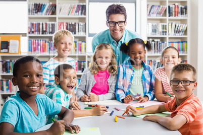 Portrait of teacher and kids in library