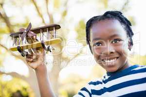 Happy child holding a plane