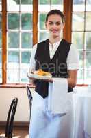 Waitress holding a plate with cakes